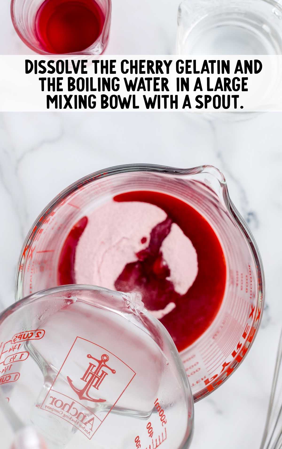 cherry gelatin and water mixed together in a measuring cup
