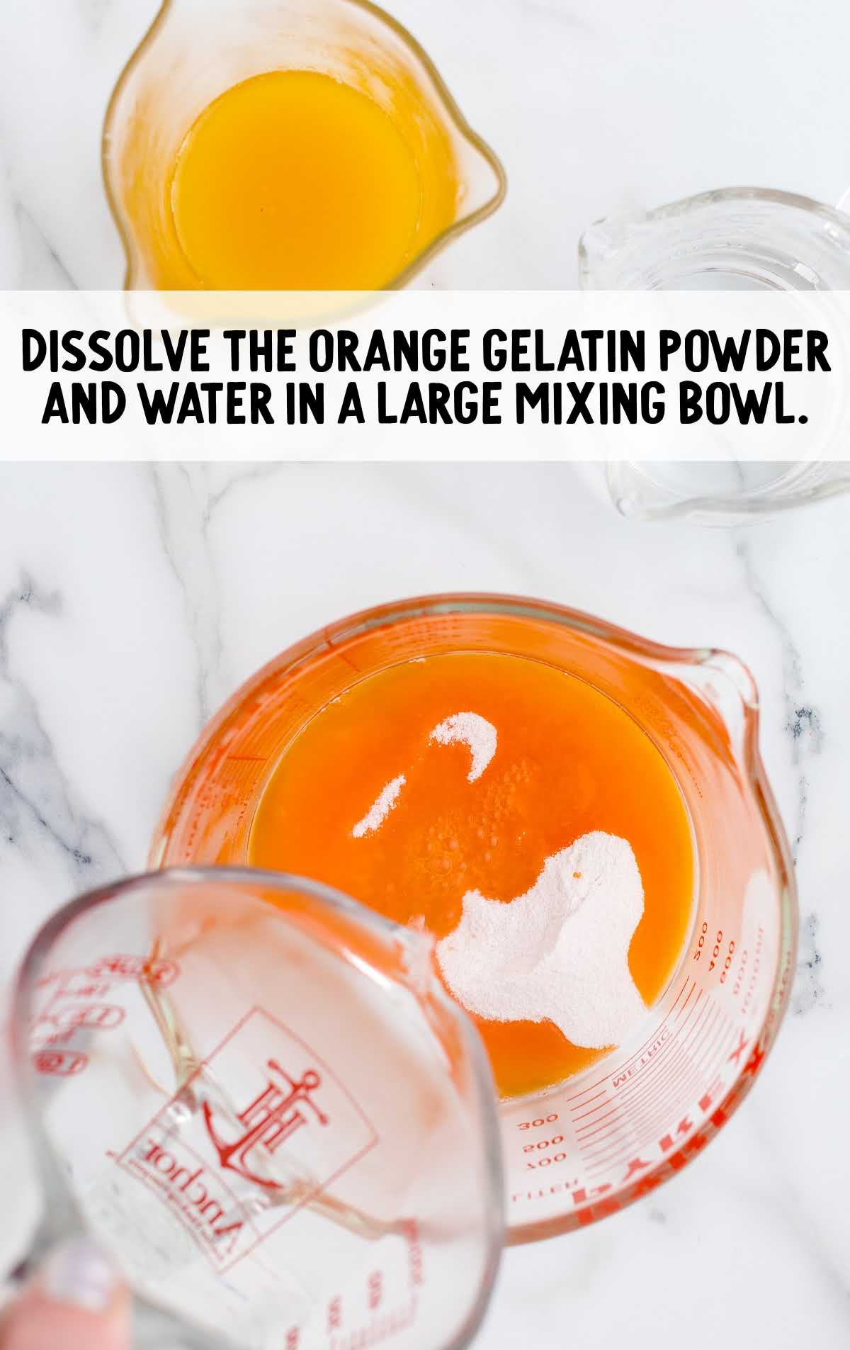 orange gelatin and water mixed together in a measuring cup