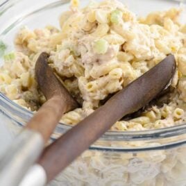 close up shot of Tuna Macaroni Salad in a bowl with tongs