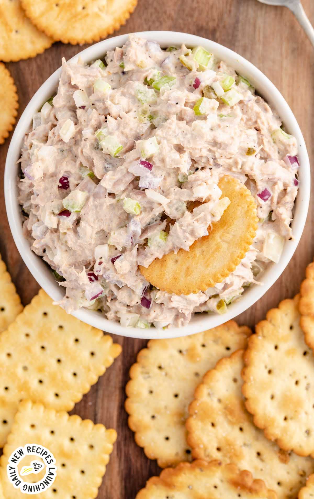 overhead shot of Tuna Salad in a bowl with a cracker