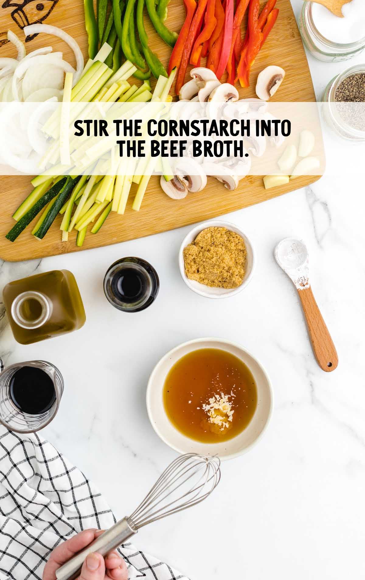 cornstarch stirred with beef broth in a cup