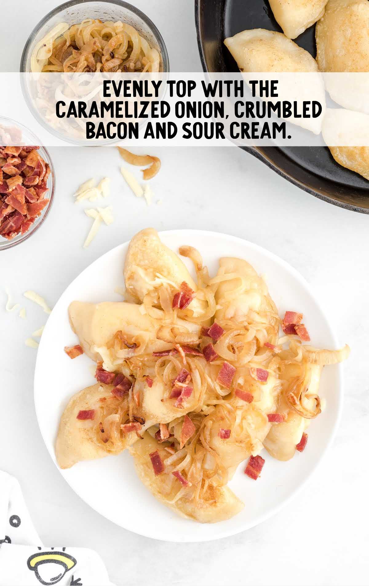 onion, crumble bacon, and sour cream topped on top of the pierogi