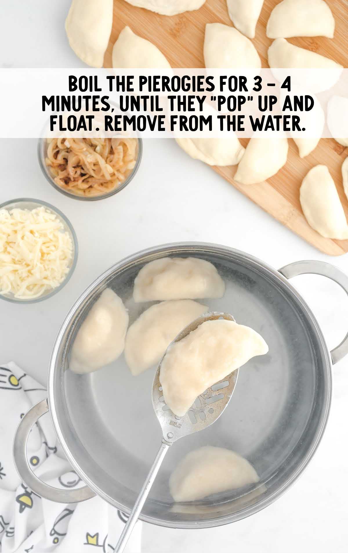 Pierogi placed in boiled water in a pot