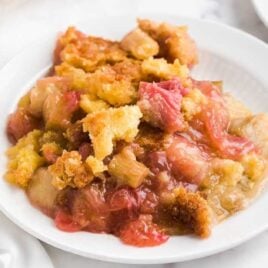 a close up shot of a piece of Rhubarb Dump Cake on a plate