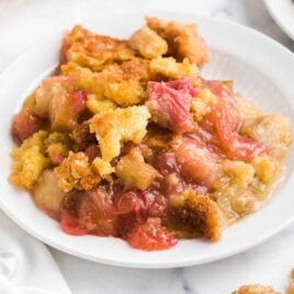 a close up shot of a piece of Rhubarb Dump Cake on a plate