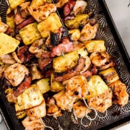 overhead shot of BBQ Chicken Kabobs with Bacon and Pineapple in a sheet pan