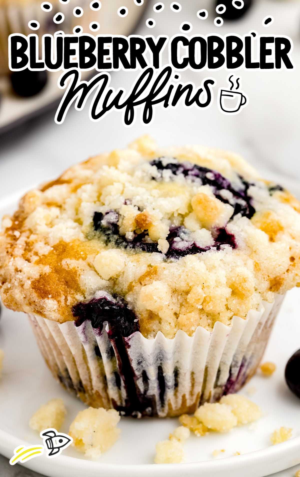 a close up shot of Blueberry Cobbler Muffins on a plate