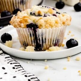 a close up shot of Blueberry Cobbler Muffins on a plate