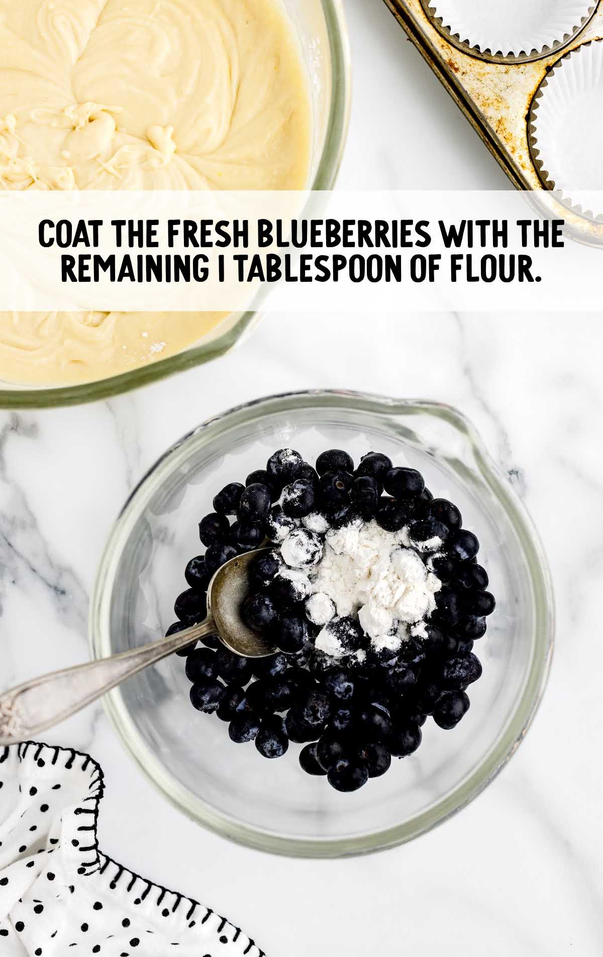 blueberries coated with flour in a bowl