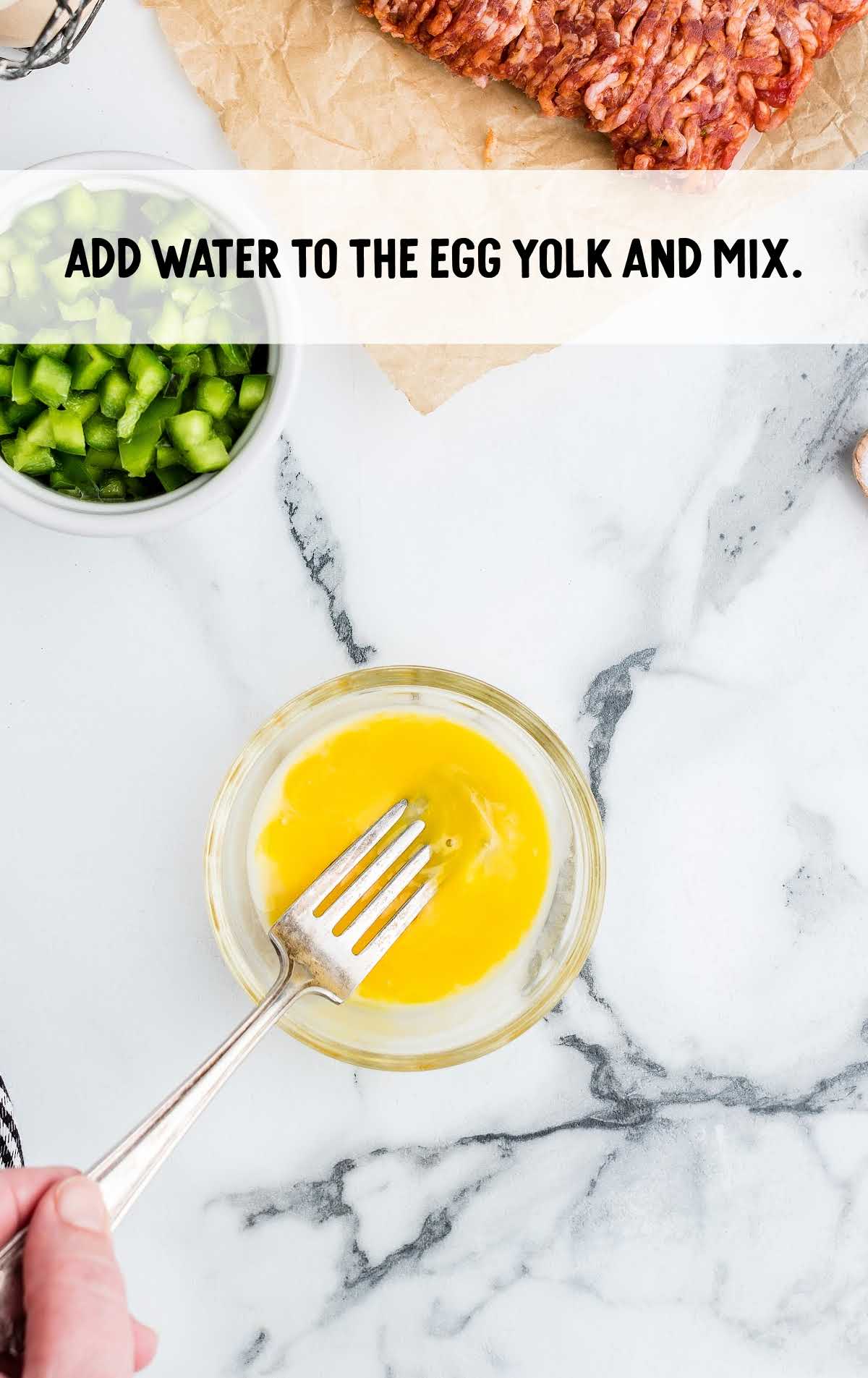 water added to the egg yolk and mix in a cup