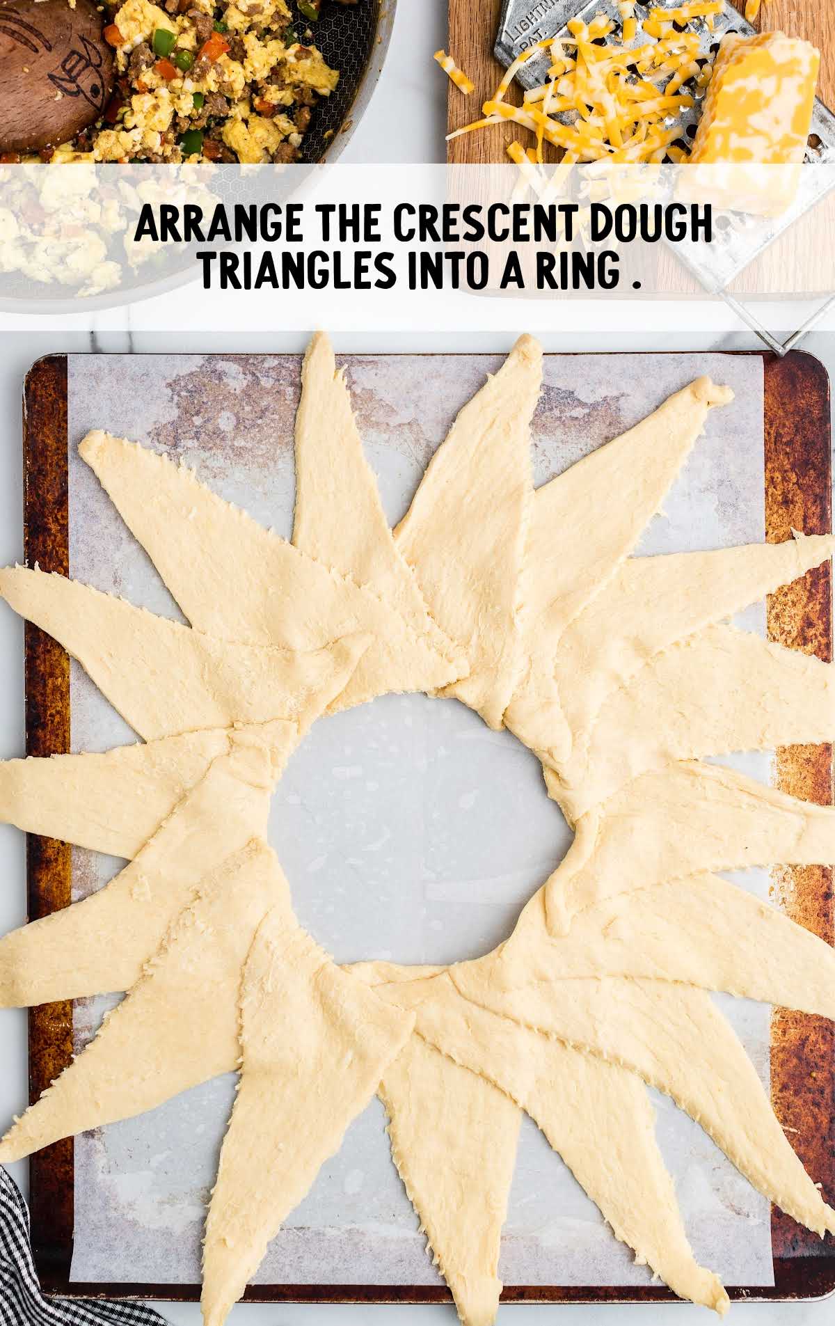 crescent dough arranged in triangles in a sheet pan