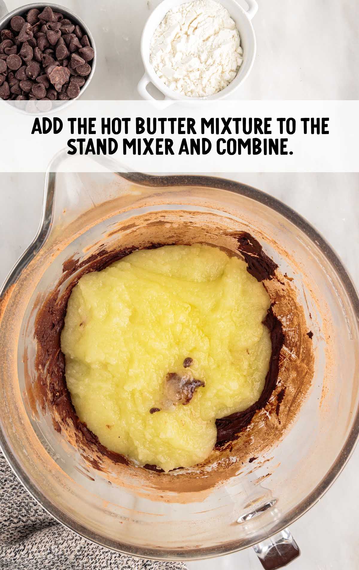 hot butter mixture added to the stand mixture in a cup