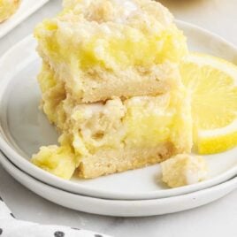 close up shot of Lemon Pie Bars stacked on top of each other