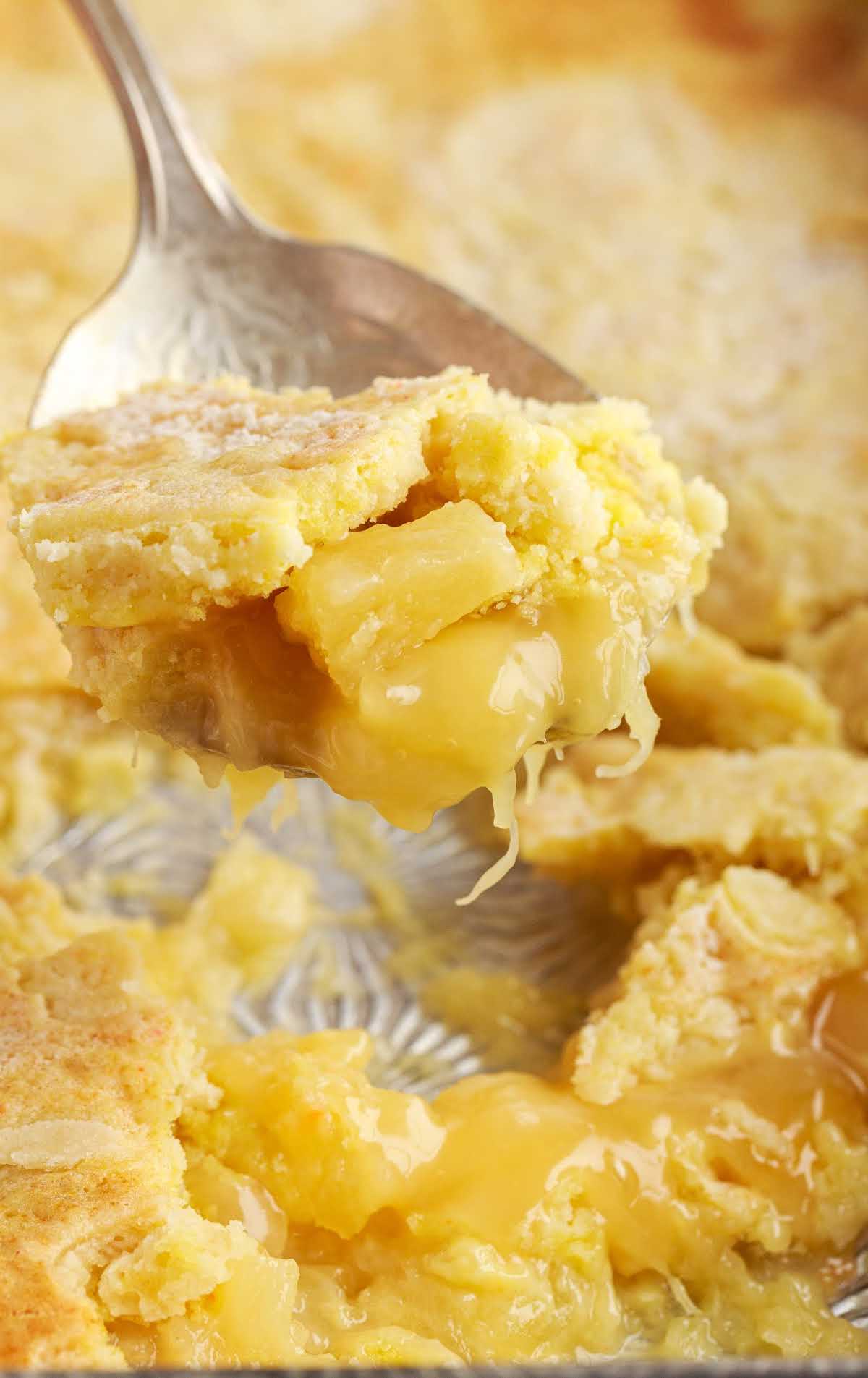 close up shot of a spoon with a piece Lemon Pineapple Dump Cake