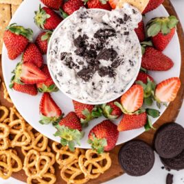 overhead shot of Oreo Dip in a bowl with strawberry slices on a plate