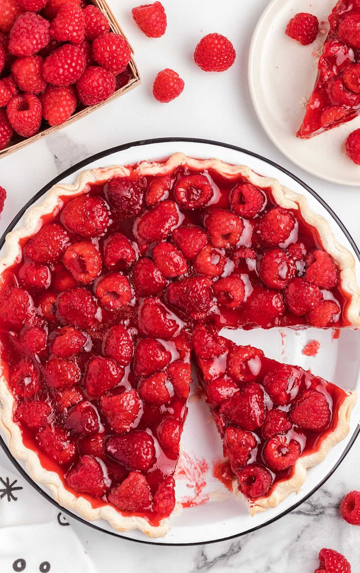 overhead shot of Raspberry pie on a plate with a slice taken out