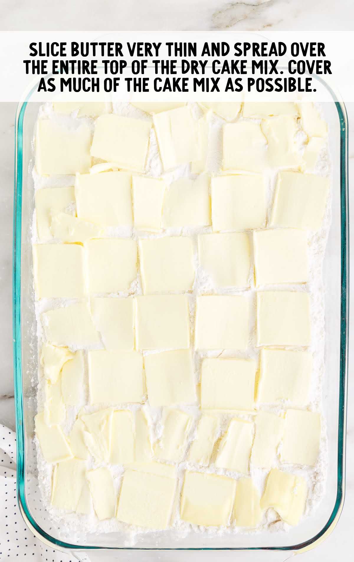 butter sliced and placed over the dry cake mix in a baking dish