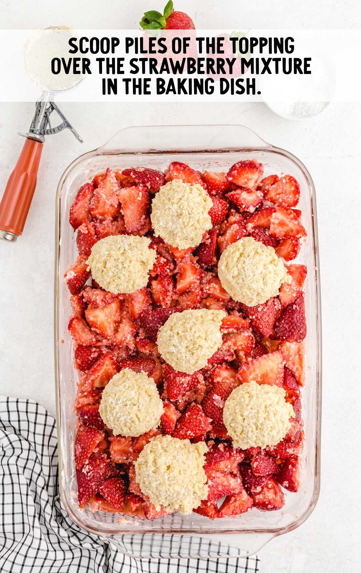 topping placed on top of the strawberry mixture in a baking dish