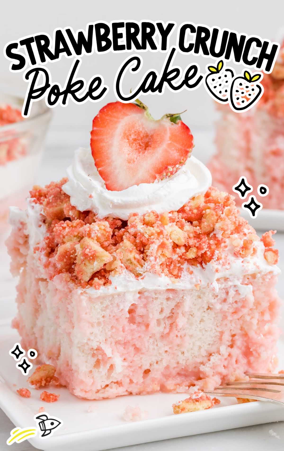 close up shot of a slice of Strawberry Crunch Poke Cake topped with whipped cream and a strawberry on a plate with a fork