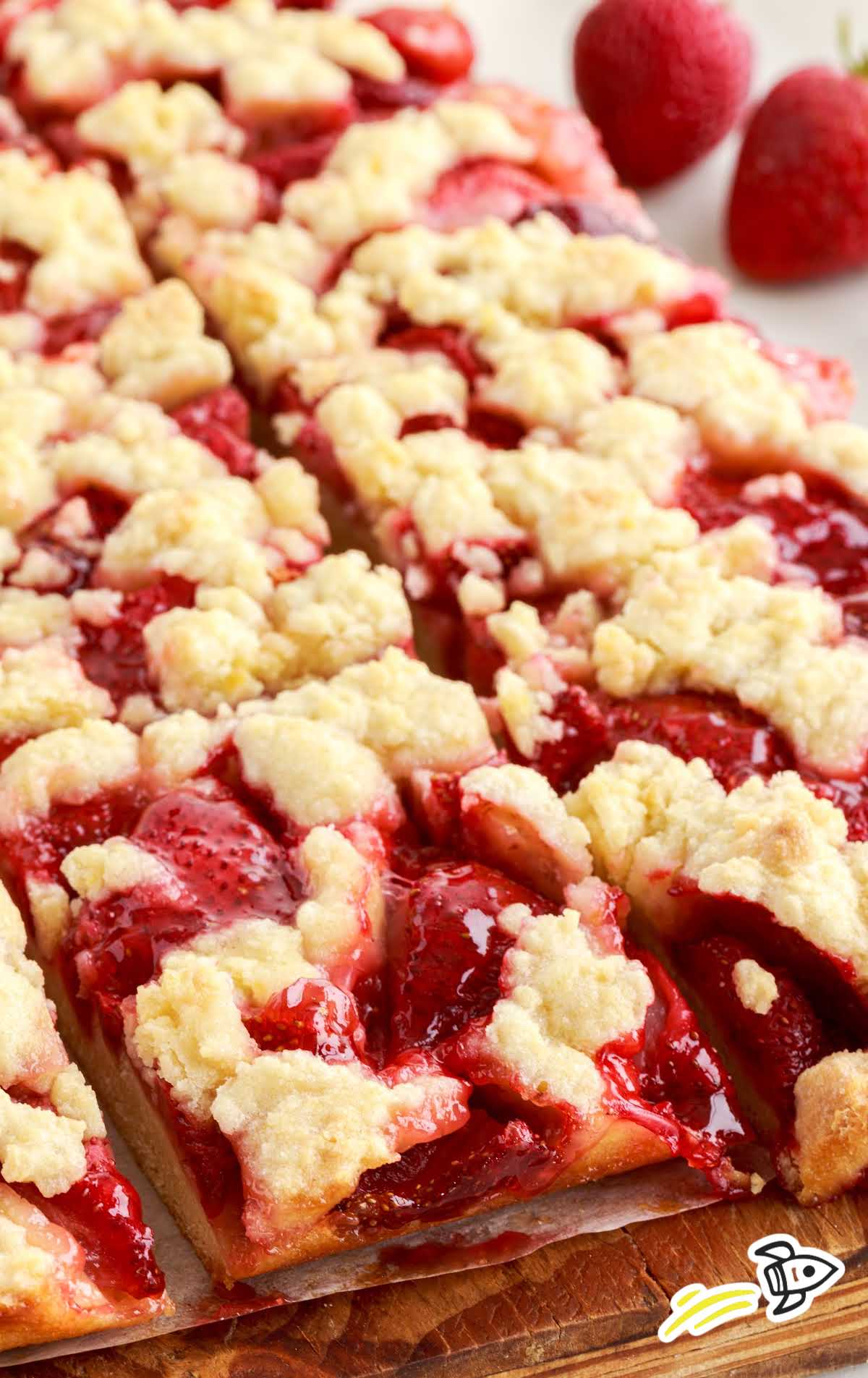 close up shot of Strawberry Pie Bars on a wooden board