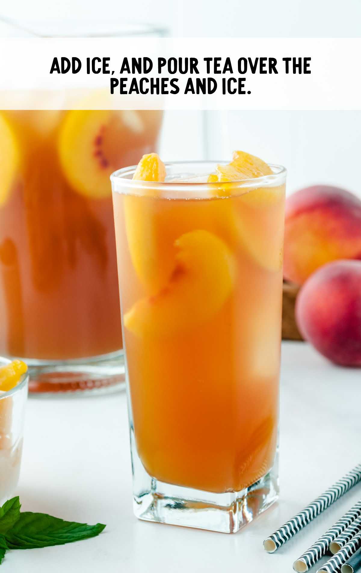 ice added and tea poured over the peaches and ice in a tall glass