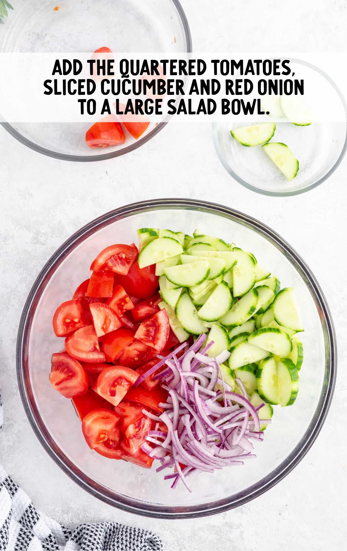 tomatoes, sliced cucumbers and red onions added to a bowl