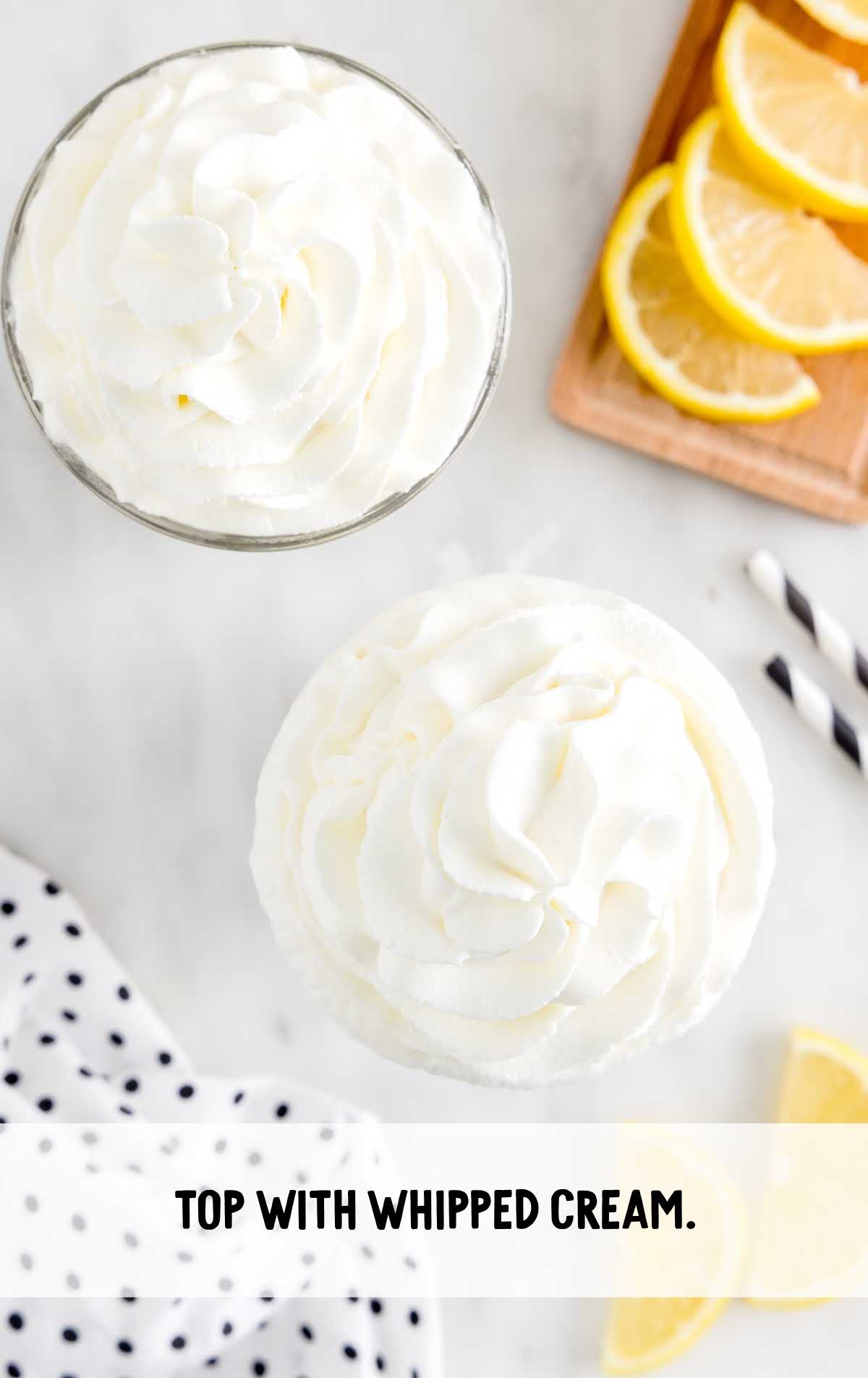 tall glass of whipped lemonade topped with Whipped cream