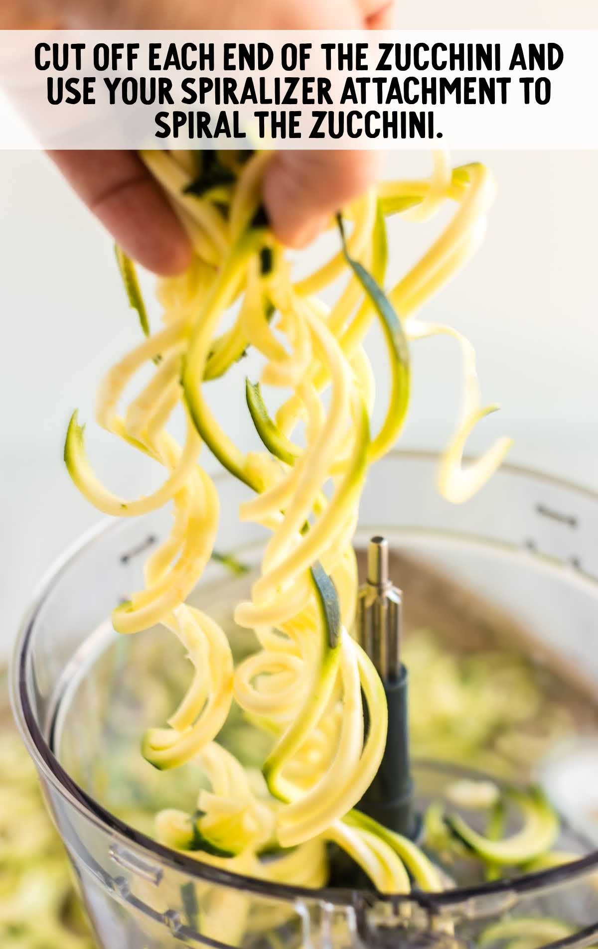zucchini placed in a blender with the spiralizer attachment