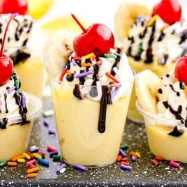 close up shot of Banana Split Jello Shots in a cup and on a table