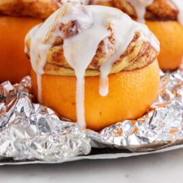 close up shot of Campfire Oranges on aluminum foil topped with icing