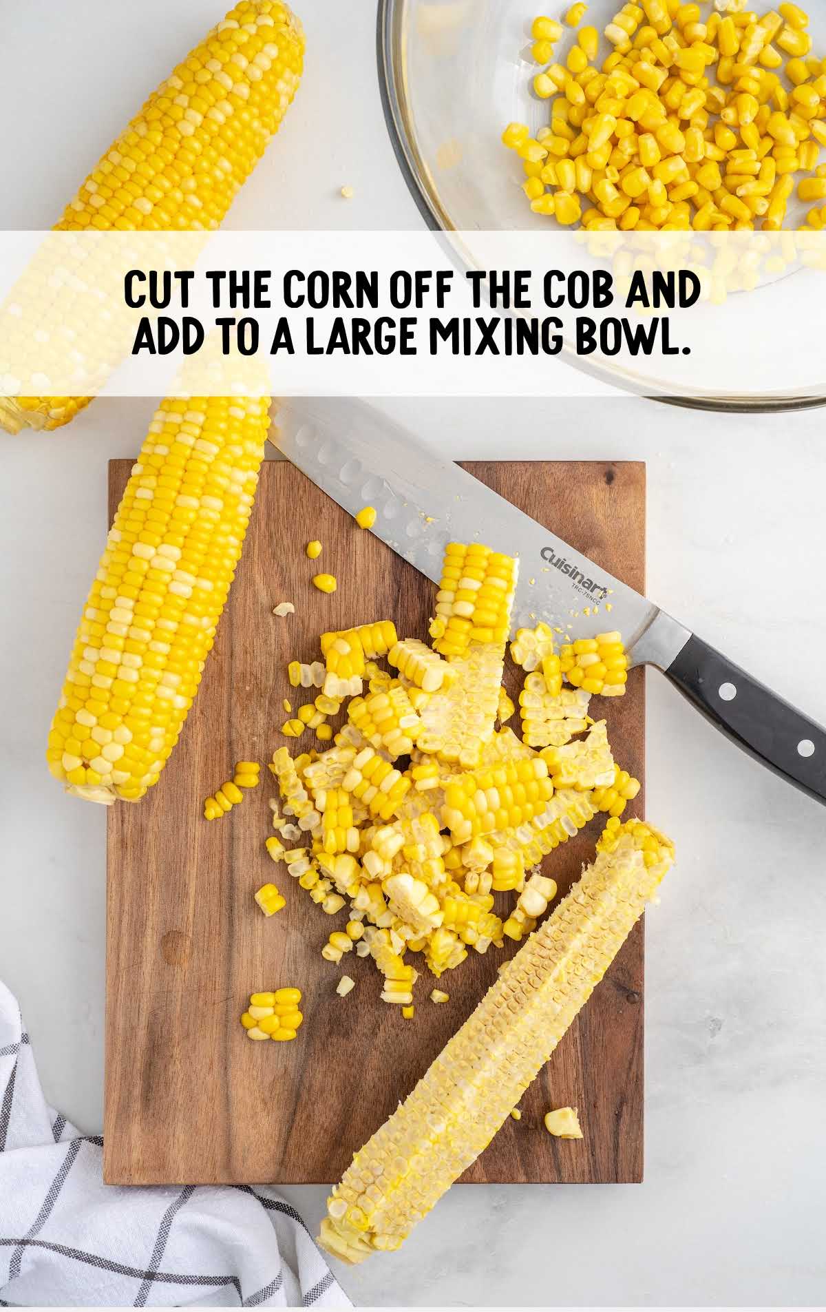 corn cut off from the cob on a cutting board and added to a large mixing bowl