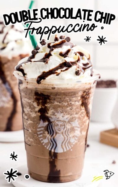 a close up shot of a Frappuccino topped with whipped cream, chocolate syrup, and chocolate chips