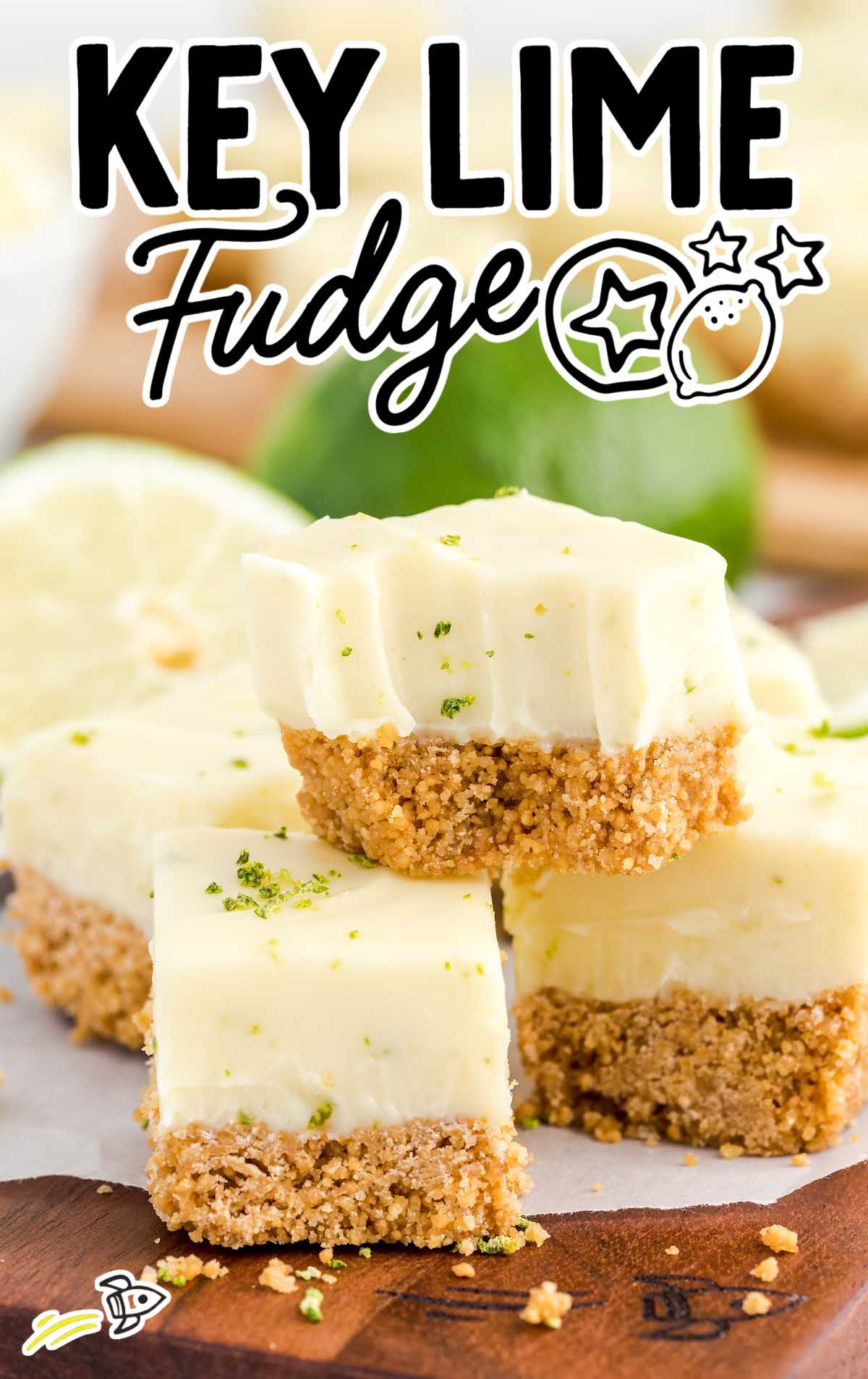 a close up shot of key lime fudge stacked on top of each other on a wooden board
