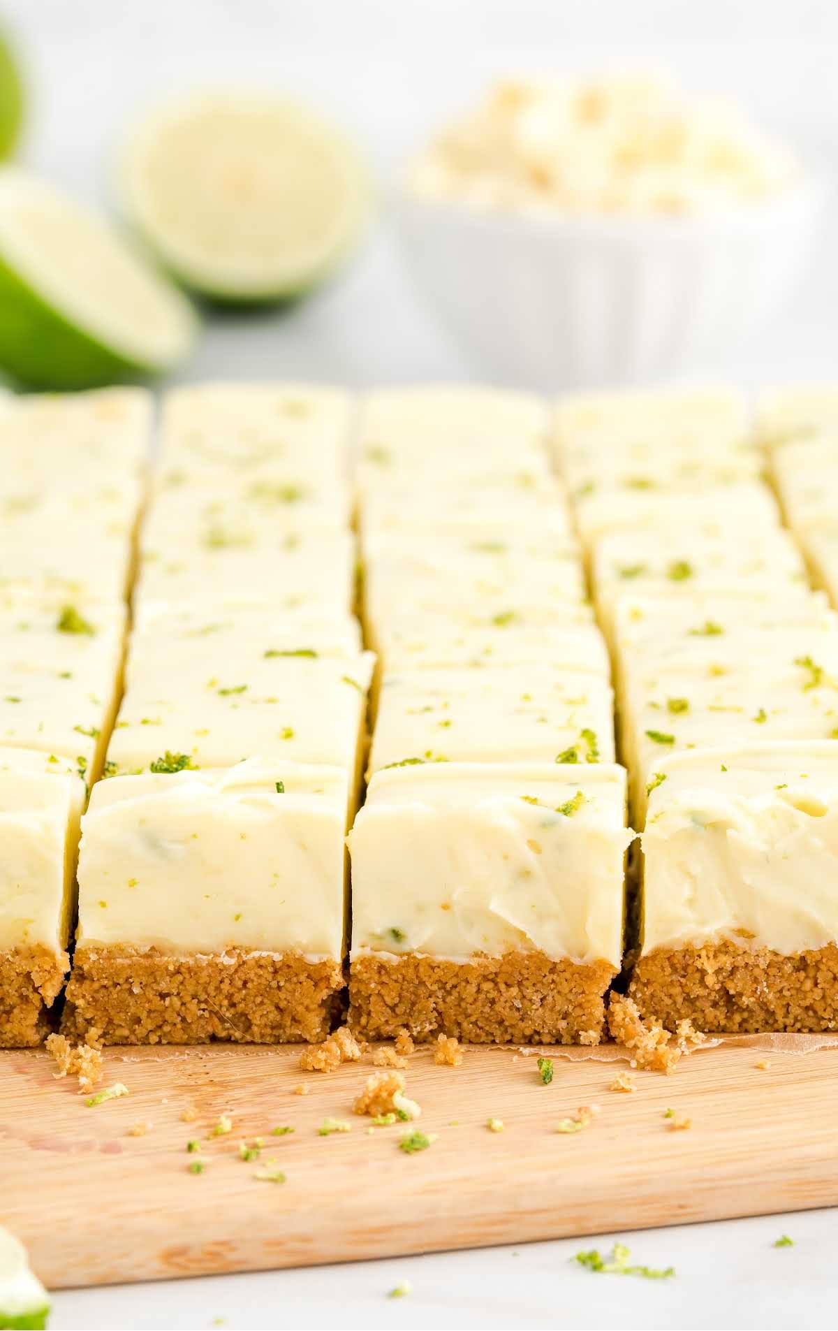 close up shot of key lime fudge sliced into squares on a wooden board