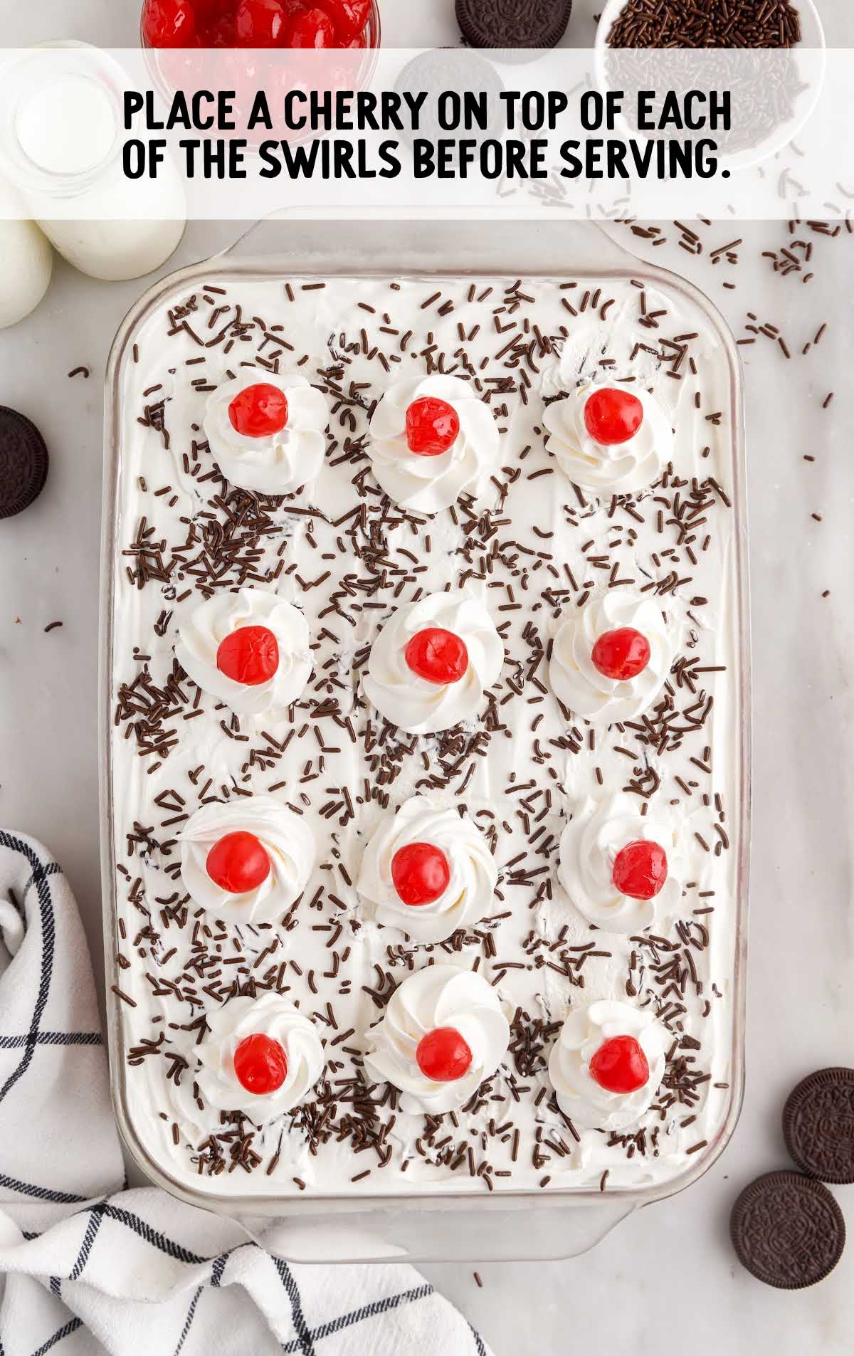 cherries placed on top of each of the swirl in a baking dish