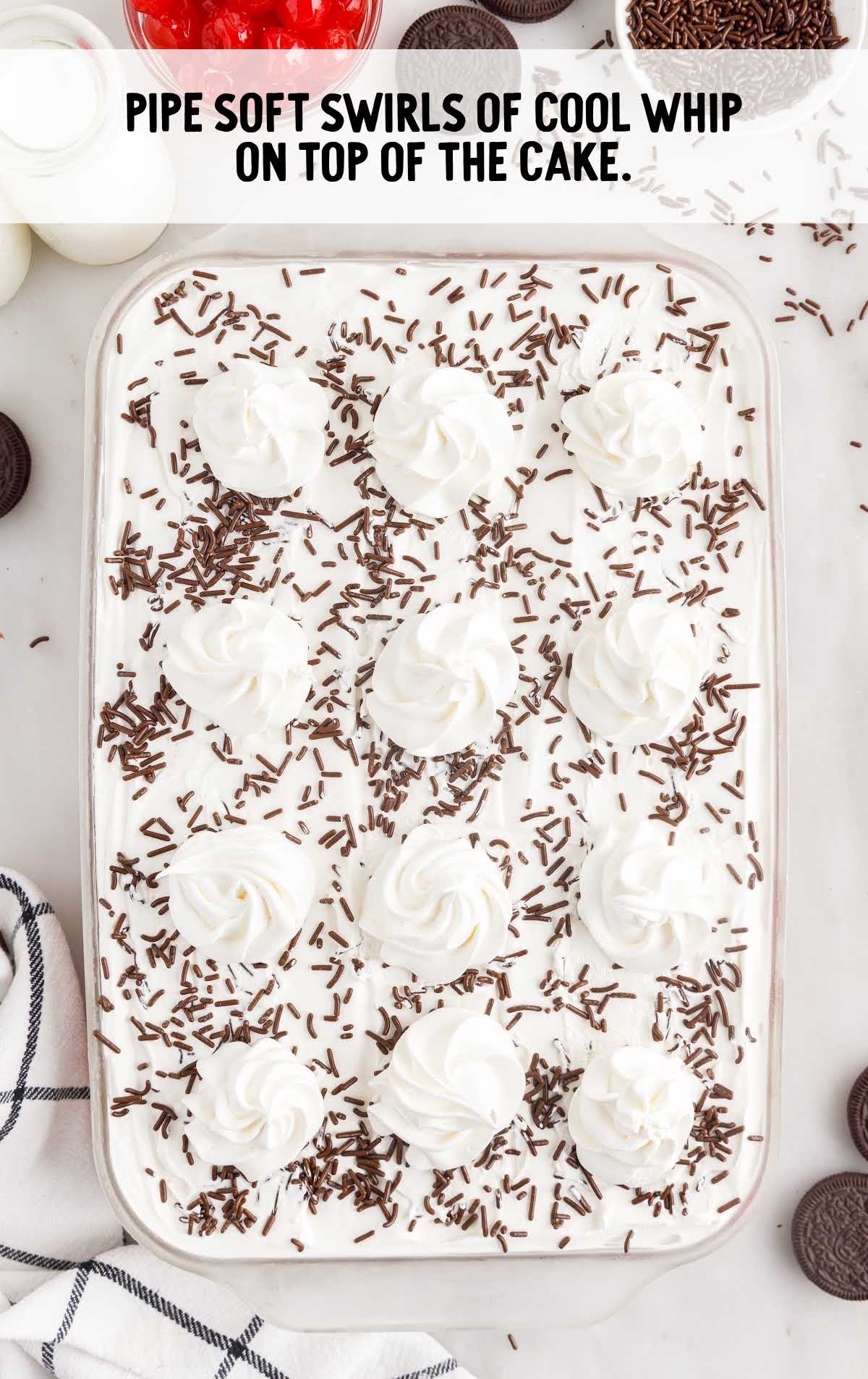swirls of cool whip piped on top of the cake