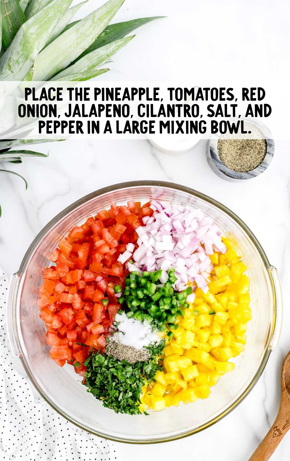 pineapple, tomatoes, red onions, jalapeño, cilantro, salt, and pepper combined in a bowl
