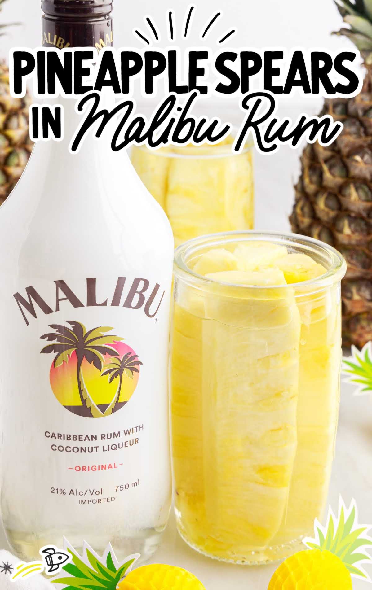 a tall container of Pineapple Spears in Malibu Rum with a bottle of Malibu