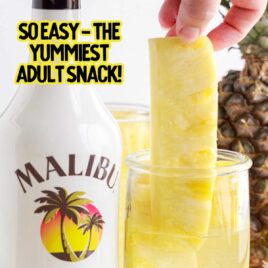 Malibu alcohol bottle and a tall container of Pineapple Spears in Malibu Rum