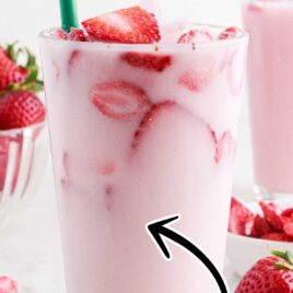 a cup of Pink Drink topped with slices of strawberries