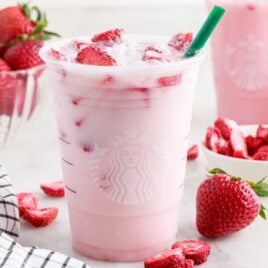 a cup of Pink Drink topped with slices of strawberries