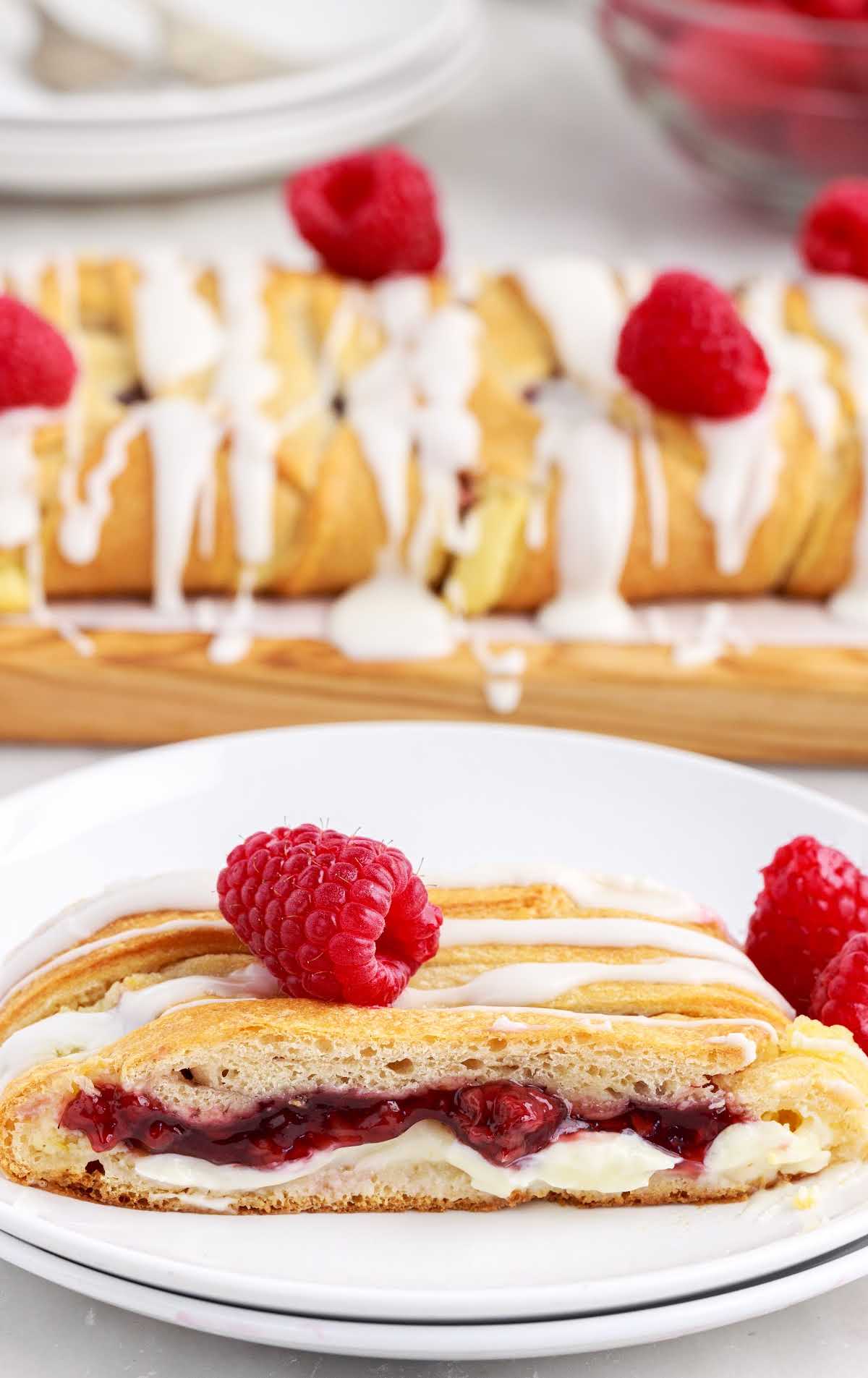 close up shot of Raspberry Breakfast Braid on a plate with raspberries on the side