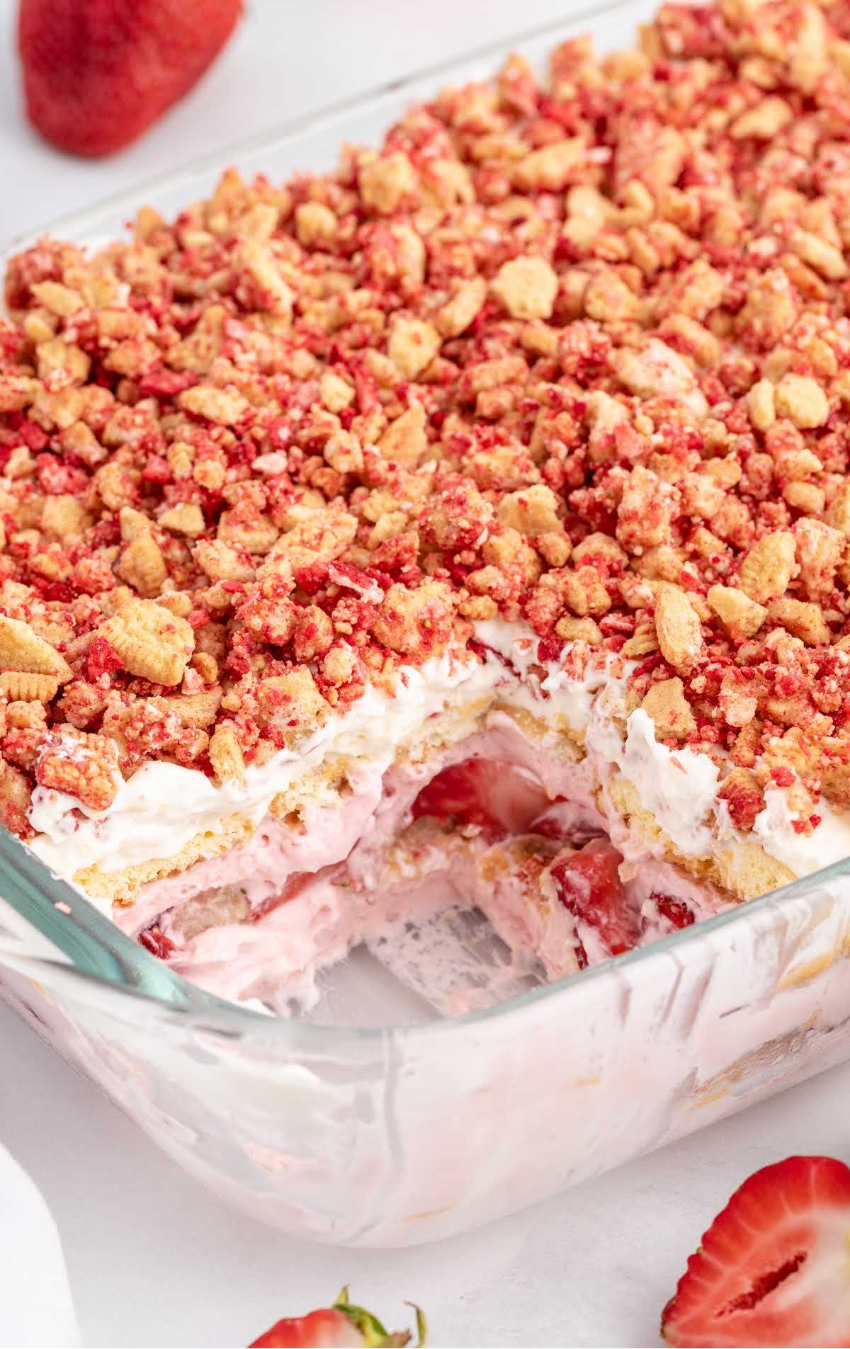 close up shot of Strawberry Shortcake Icebox Cake in a baking dish with a slice taken out