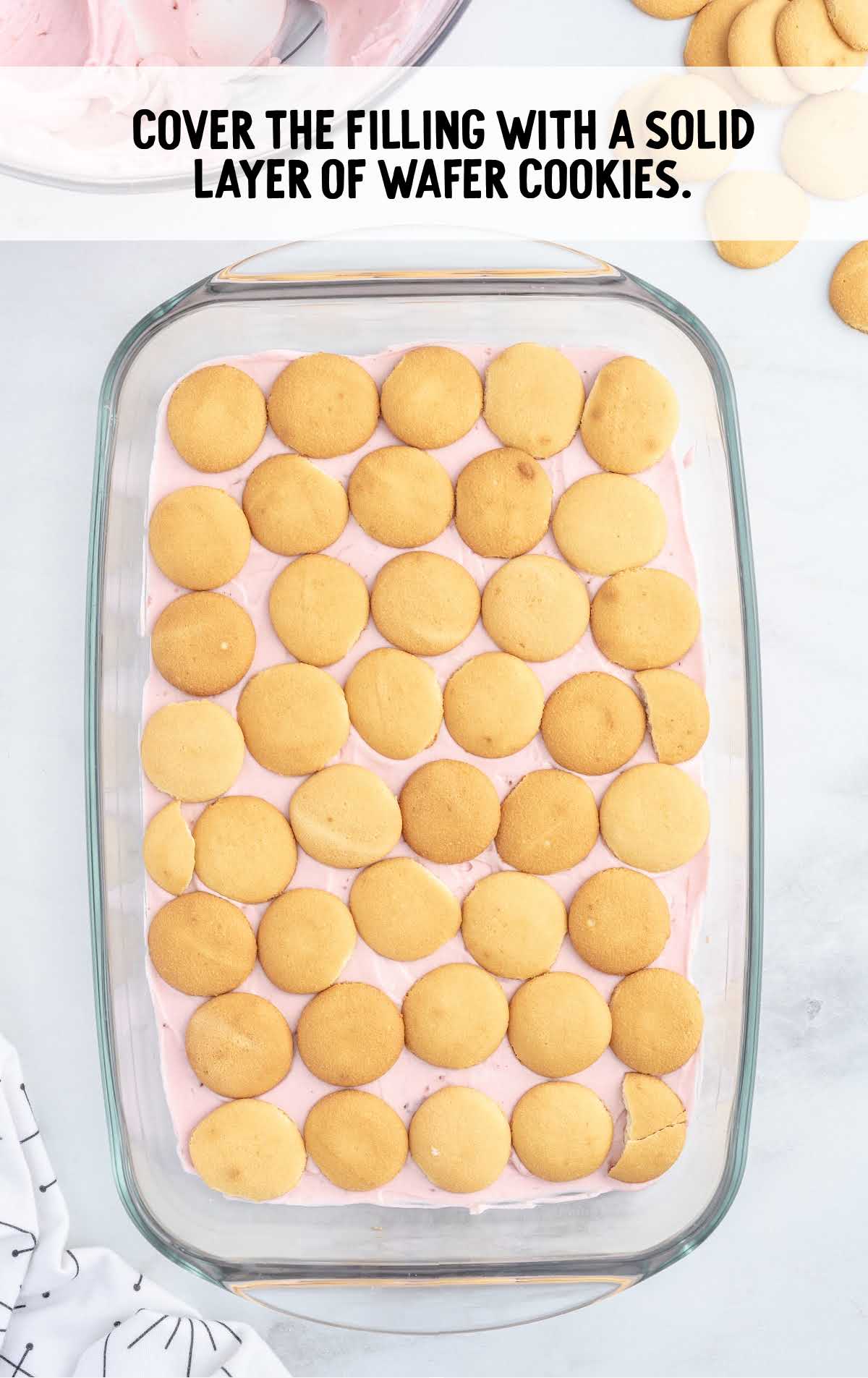 fillings covered with wafer cookies in a baking dish