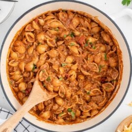overhead shot of Taco Pasta in a pot with a wooden spoon