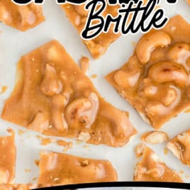 Top: Pieces of golden cashew brittle on a white surface. Bottom: Stacked Cashew Brittle tied with blue string. Text: Old Fashioned Cashew Brittle and EXCELLENT GIFT!! with an arrow pointing to the stack.