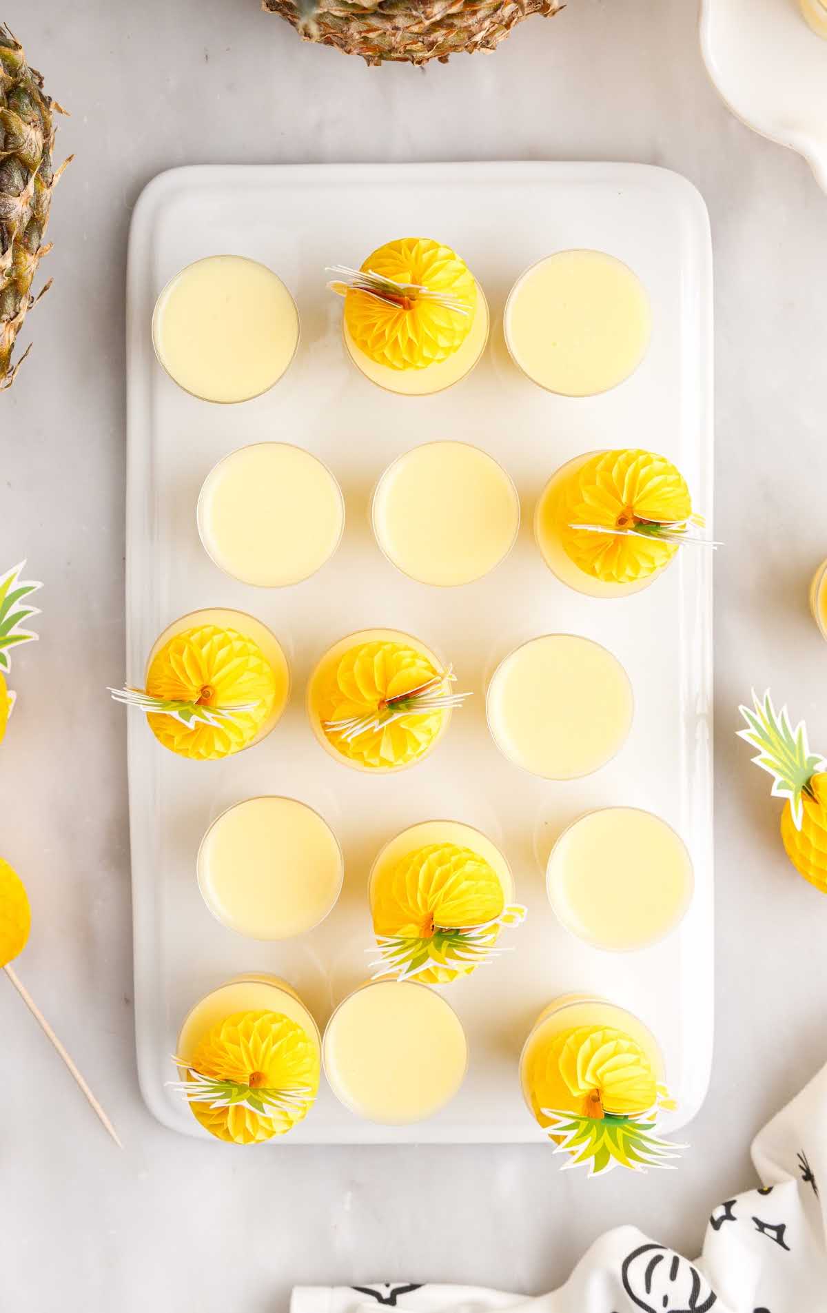 overhead shot of Dole Whip Jello Shots in cups on a tray