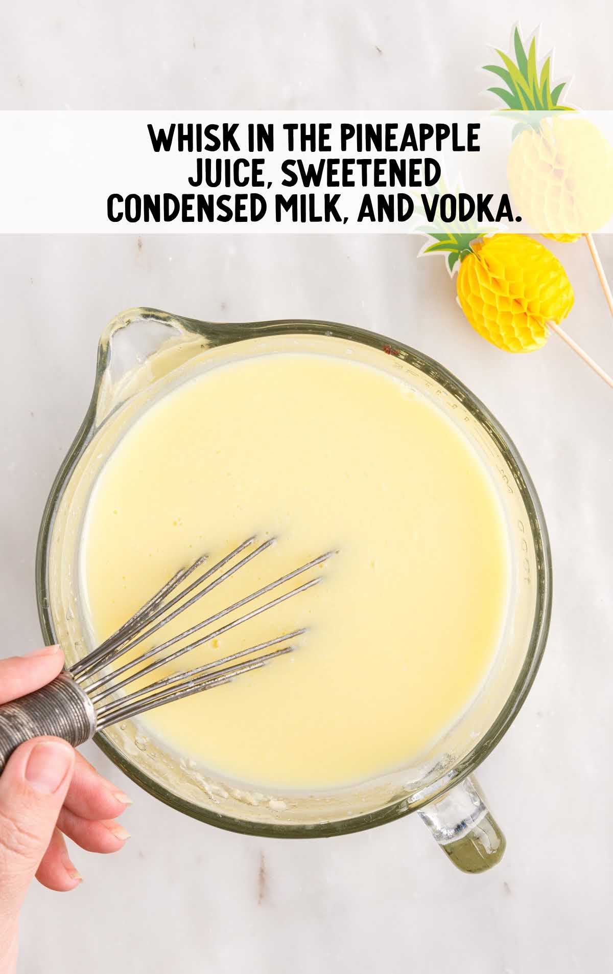 pineapple juice, sweetened condensed milk, and vodka whisked in a measuring cup