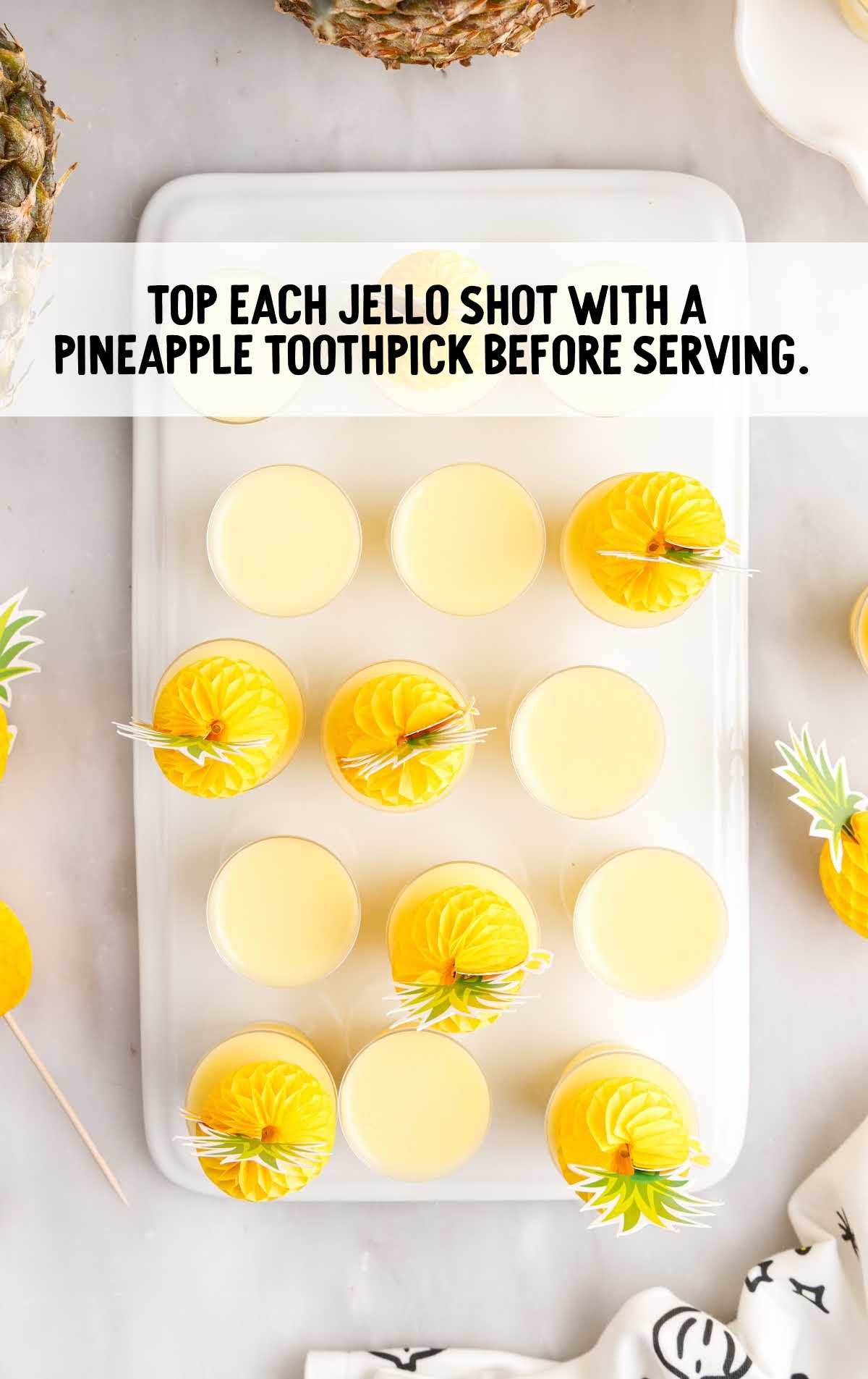 jello shot topped with pineapple toothpick on a tray