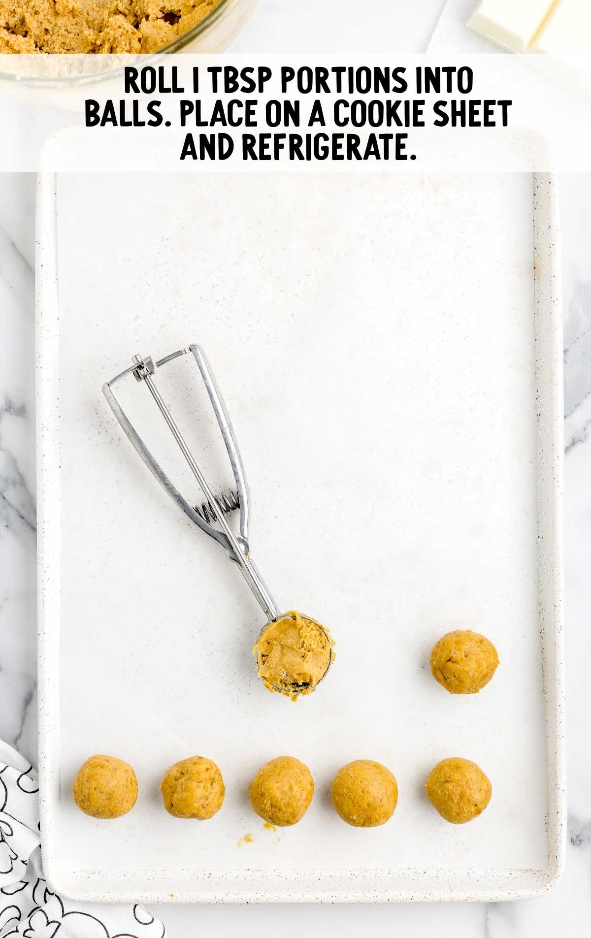 white chocolate mixture rolled into balls and placed in a cookie sheet